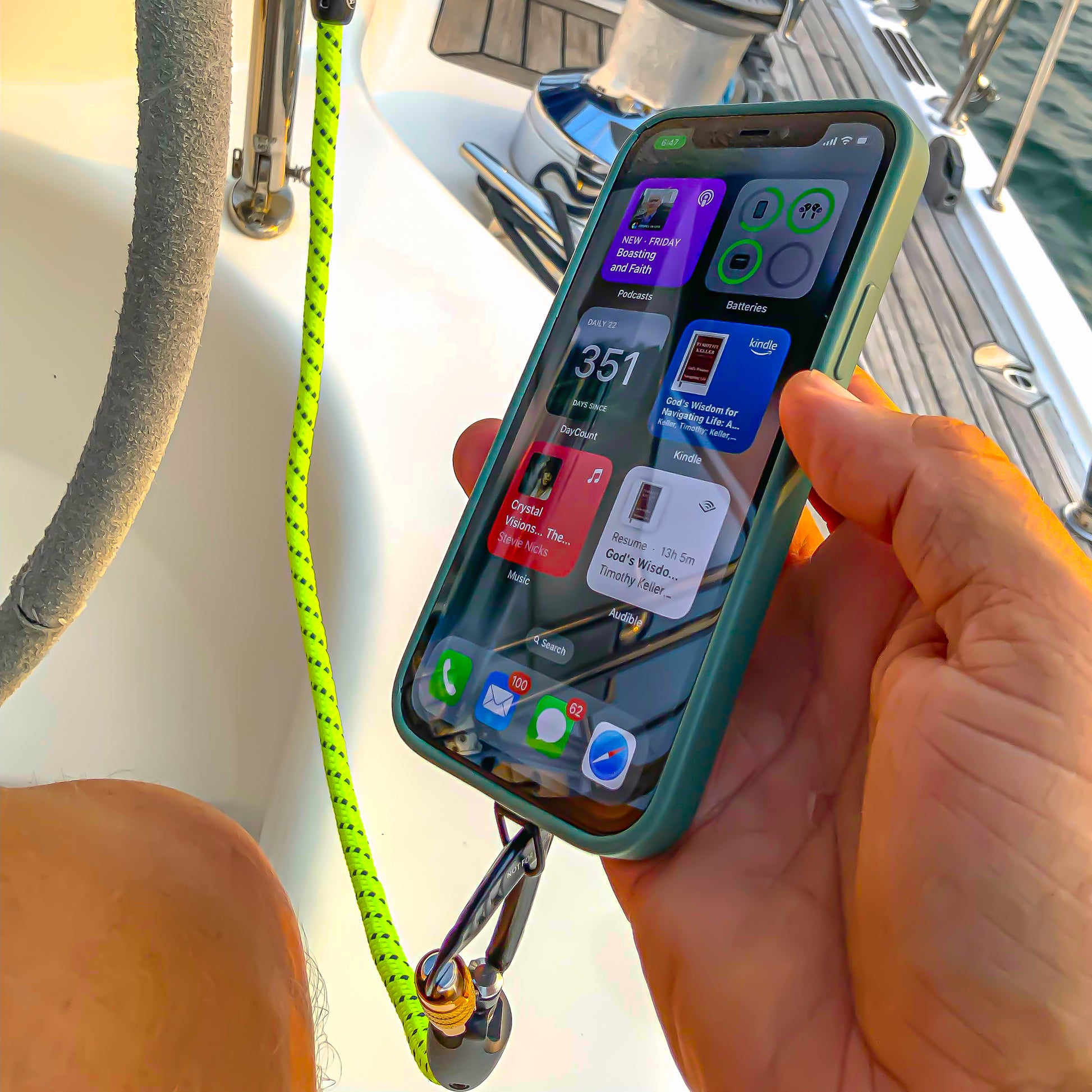 Lifestyle image showing Tuenne phone and gear tether in use outdoors boating