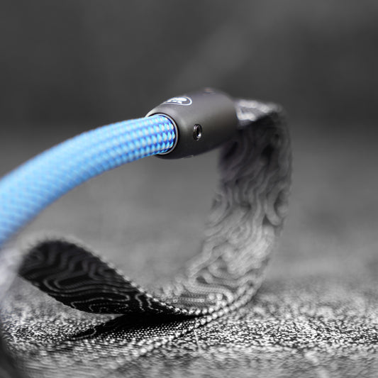 detail of the handle of a blue rope dog leash made with climbing rope on a slate board