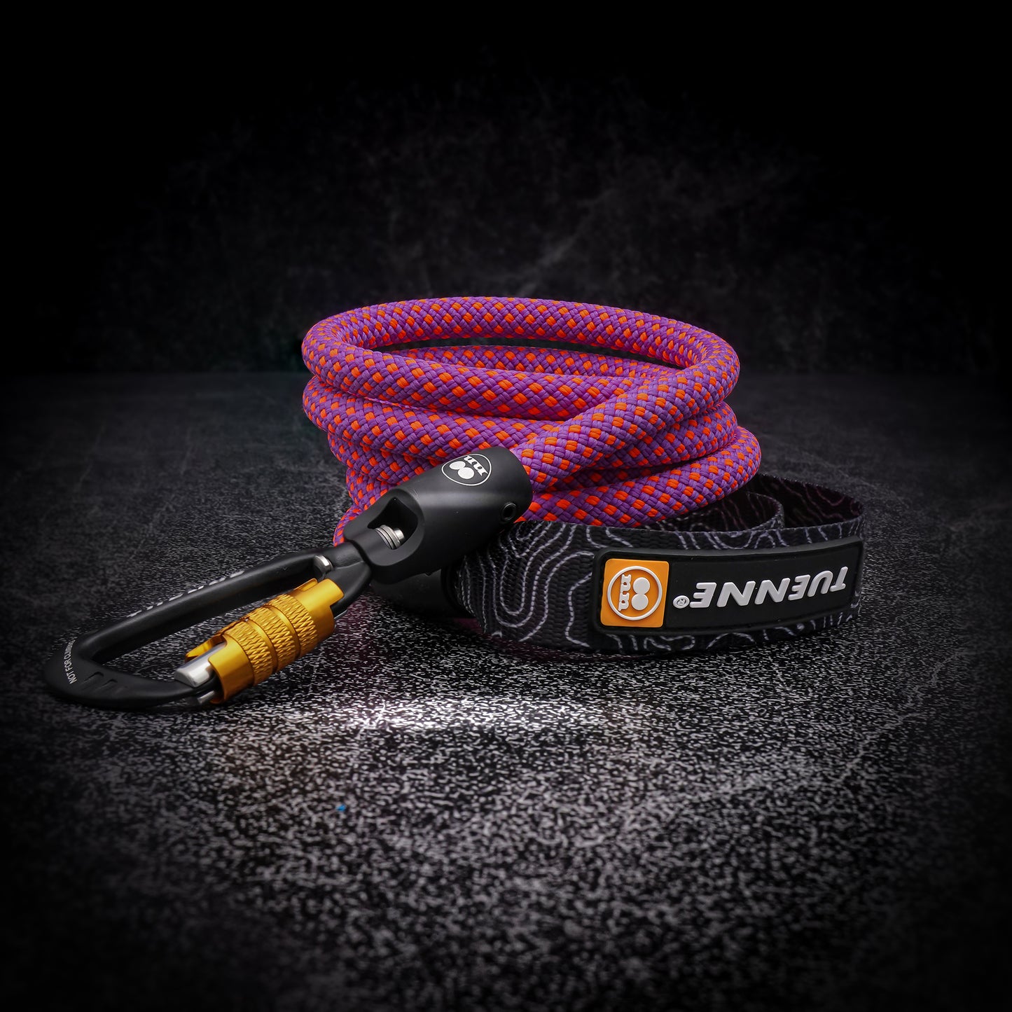 Pink and purple Mammut rope dog leash with auto-locking carabiner on dark background