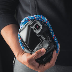 Tuenne camera strap attached to DSLR with Peak Design clips blue
