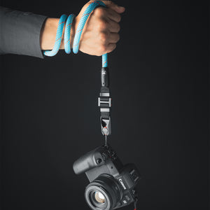 Tuenne camera strap attached to DSLR with Peak Design clips blue