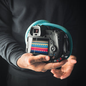 Tuenne camera strap attached to DSLR with Peak Design clips green