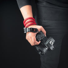 Tuenne camera strap attached to DSLR with Peak Design clips red