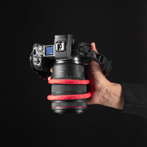 Tuenne camera strap attached to DSLR with Peak Design clips red