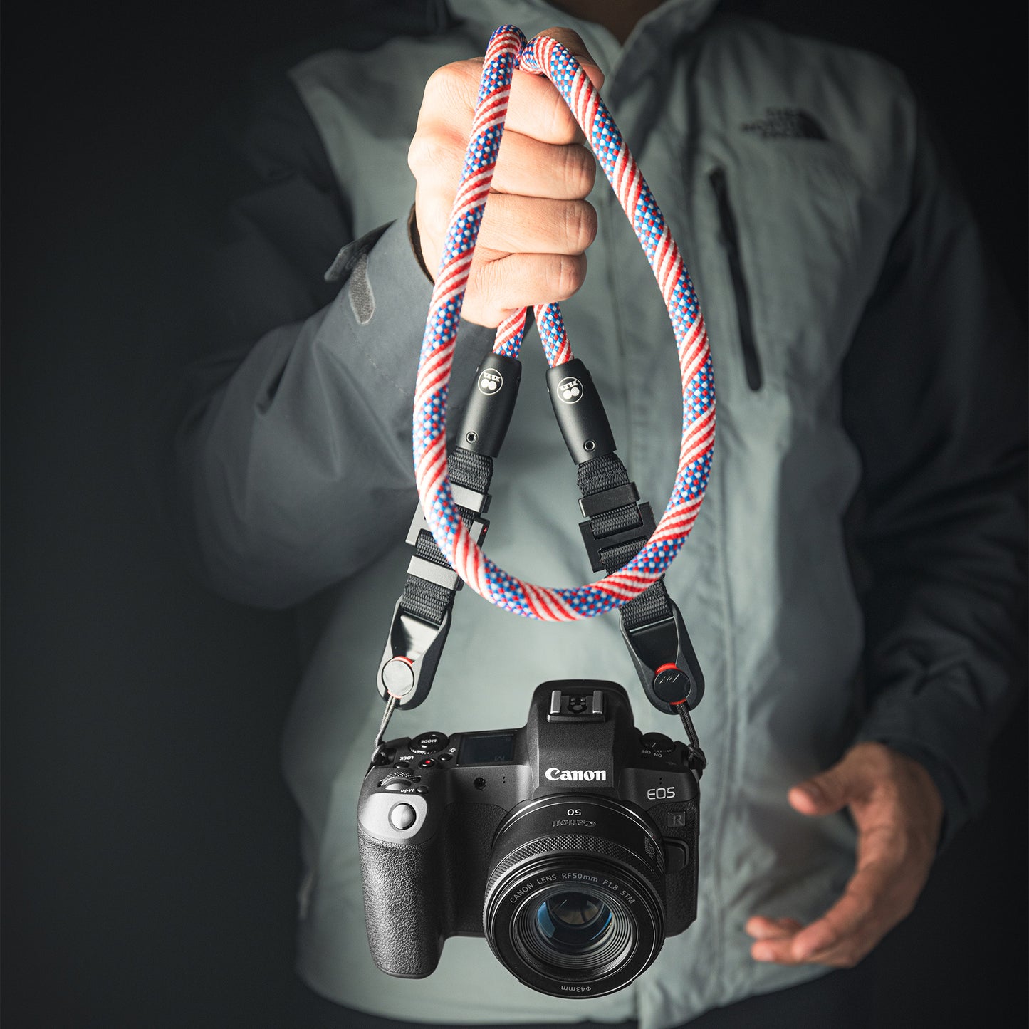 Tuenne camera strap attached to DSLR with Peak Design clips blue red flag