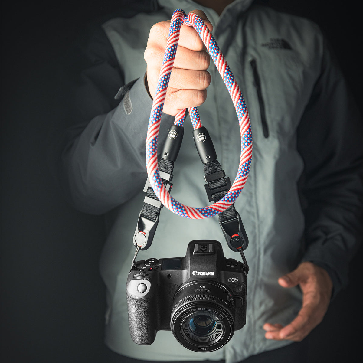 Tuenne camera strap attached to DSLR with Peak Design clips blue red flag