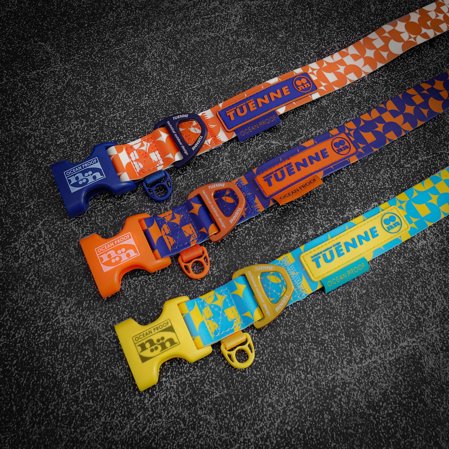 Close-up of silicone-coated waterproof dog collars by Tuenne, in orange, blue and yellow