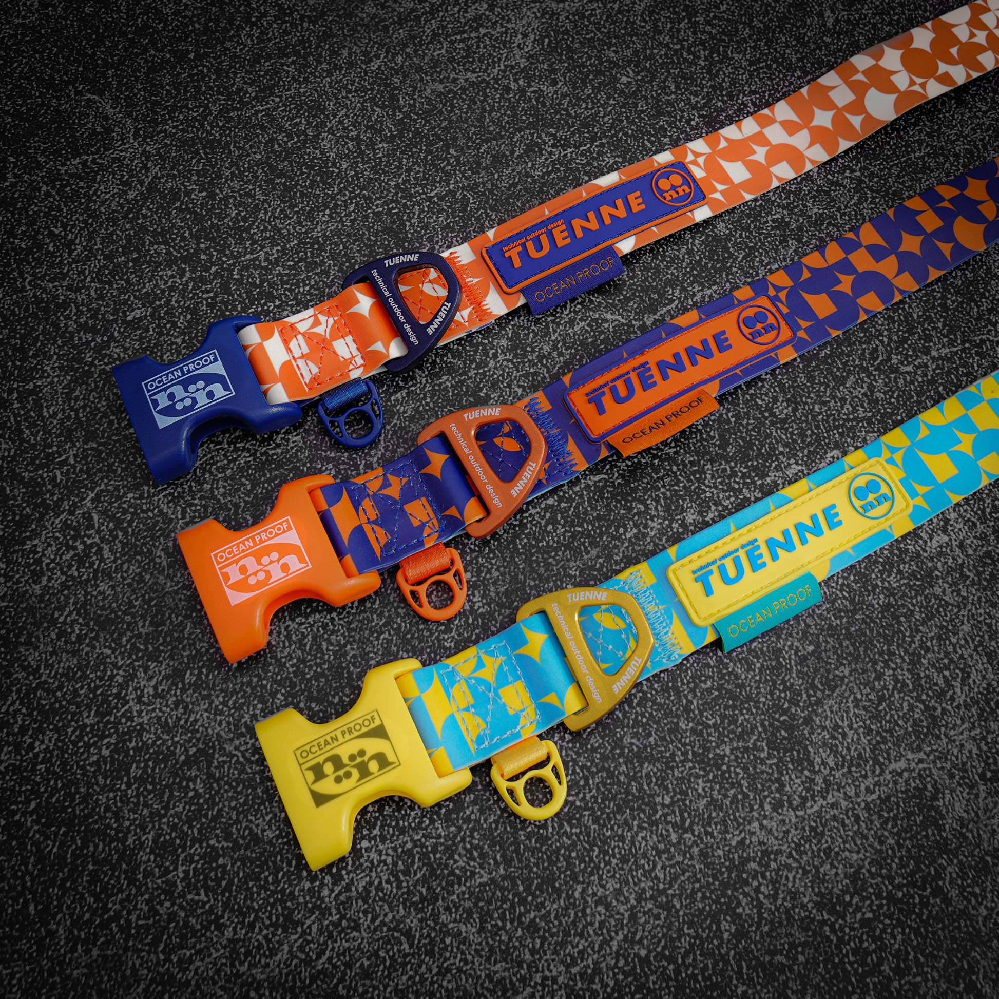 Close-up of silicone-coated waterproof dog collars by Tuenne, in orange, blue and yellow