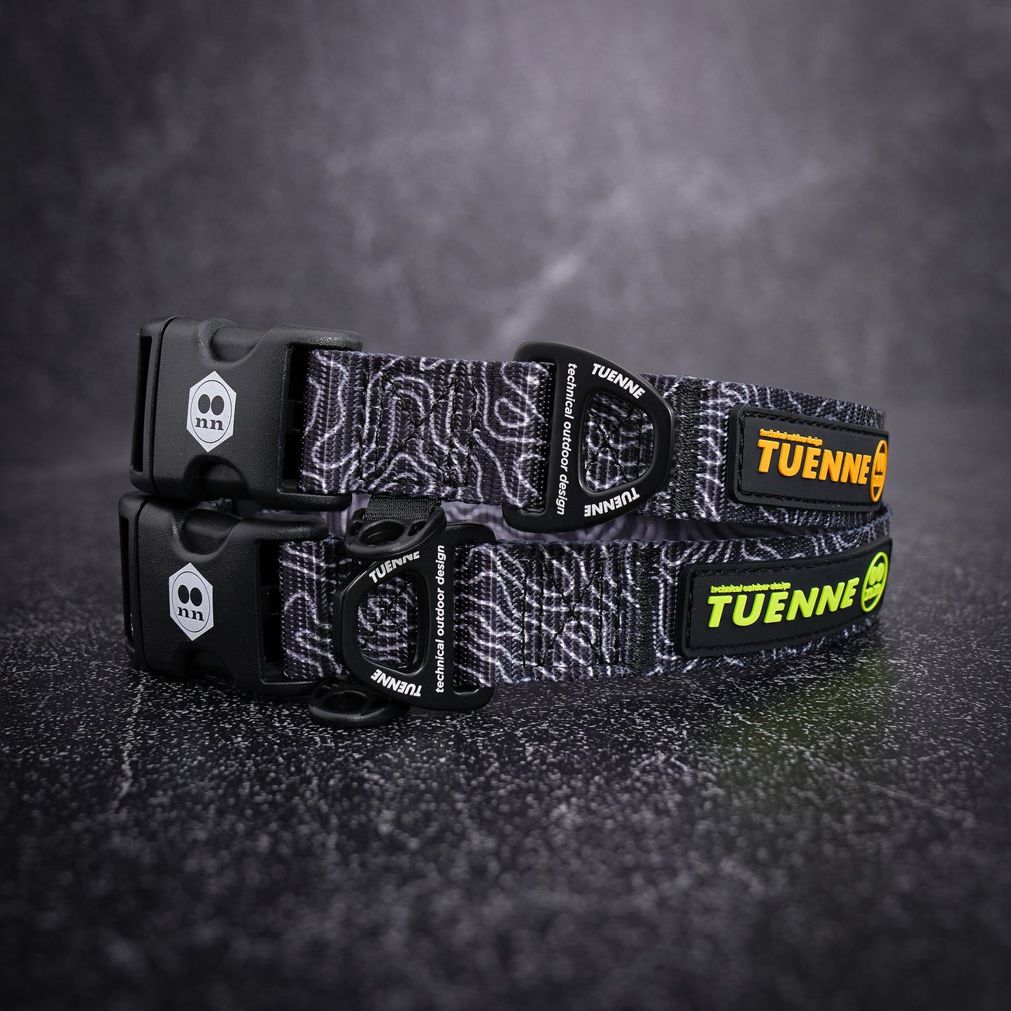 topographic patterned dog collar with visible branding on a dark textured background