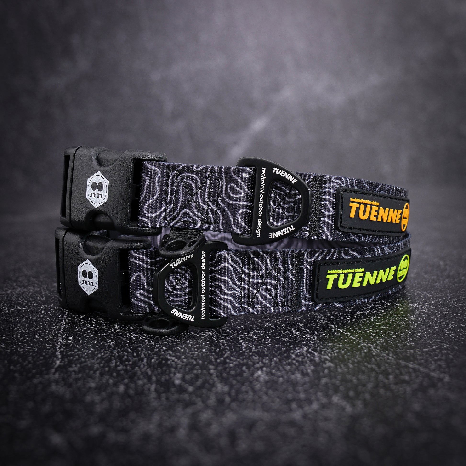 topographic patterned dog collar with visible branding on a dark textured background