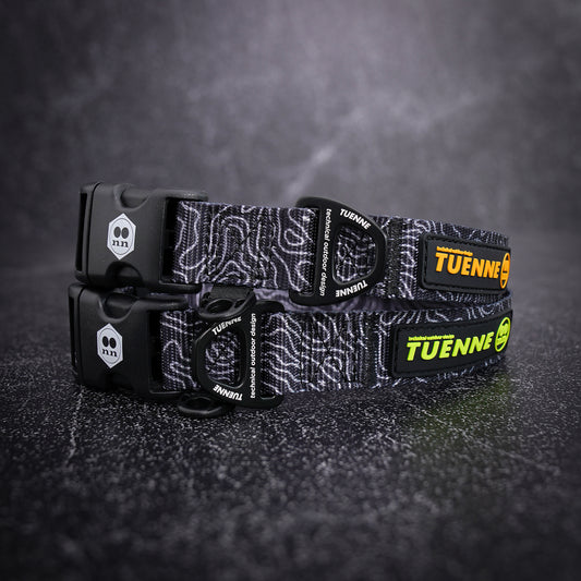 topographic patterned dog collar with visible branding on a dark textured background