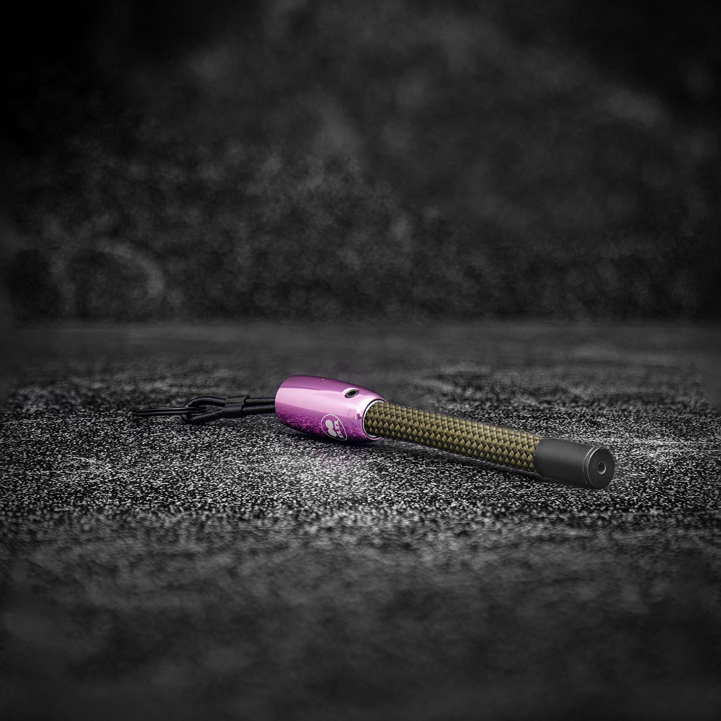 Close-up view of the Yellowstone Rope Keychain showing steel and rope details pink aluminum