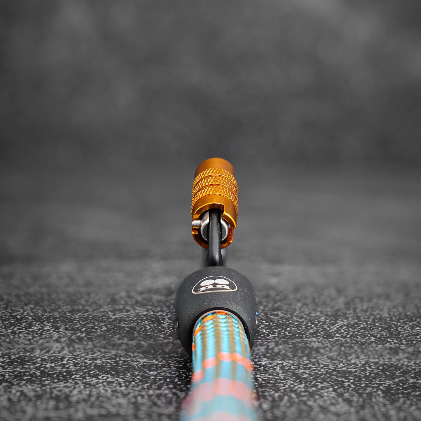 close-up of  the carabiner on a rope dog leash using Mammut climbing rope on a gray bokeh background