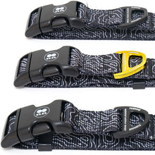 Close-up of Tuenne Black Topographic Dog Collar showing gold and black D-ring and reinforced stitching