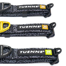 Close-up of Tuenne Black Topographic Dog Collar showing gold and  D-ring and reinforced stitching and logo