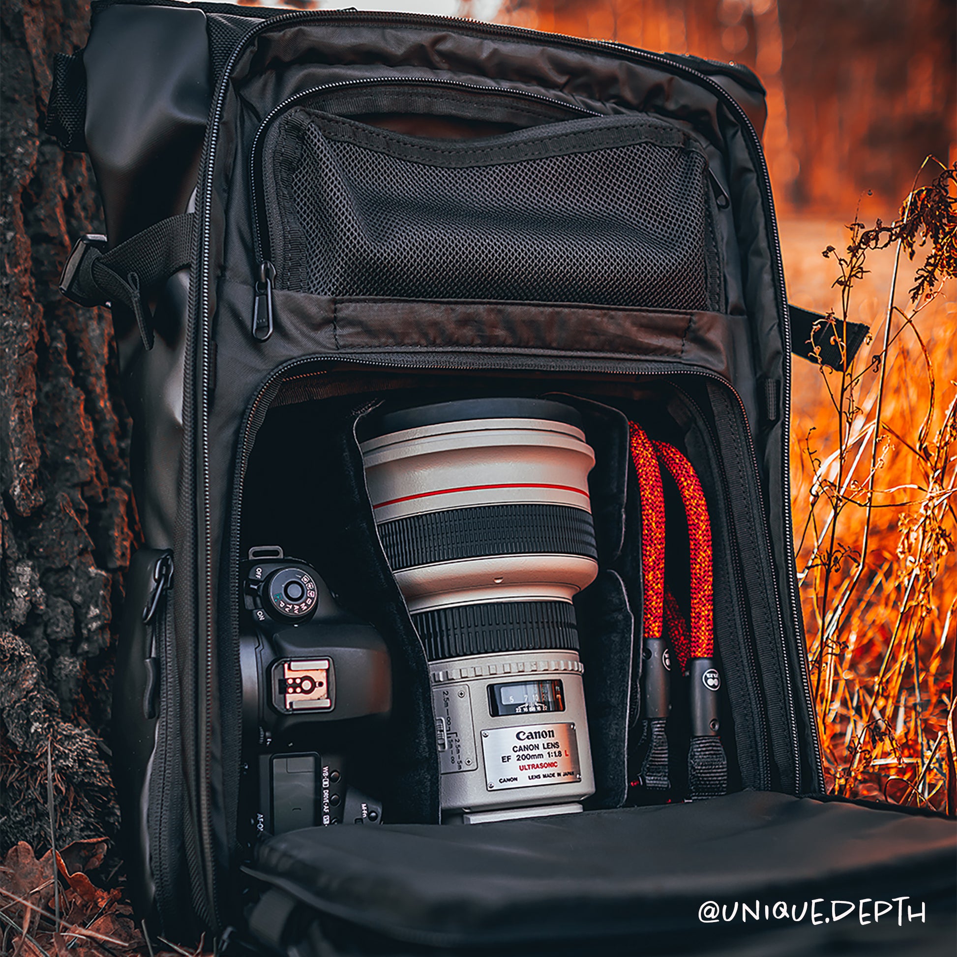 Black climbing rope camera strap compatible with Peak Design by Tuenne in camera bag orange
