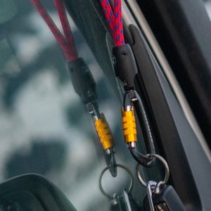 Real-life photo of Tuenne lanyard carabiner holding a car key for secure everyday carry